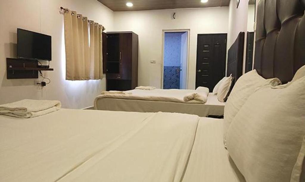 Postel nebo postele na pokoji v ubytování Hotel Balaji Inn Baga