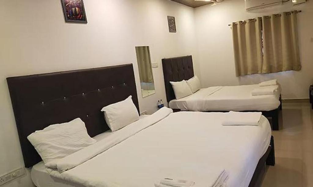 Postel nebo postele na pokoji v ubytování Hotel Balaji Inn Baga