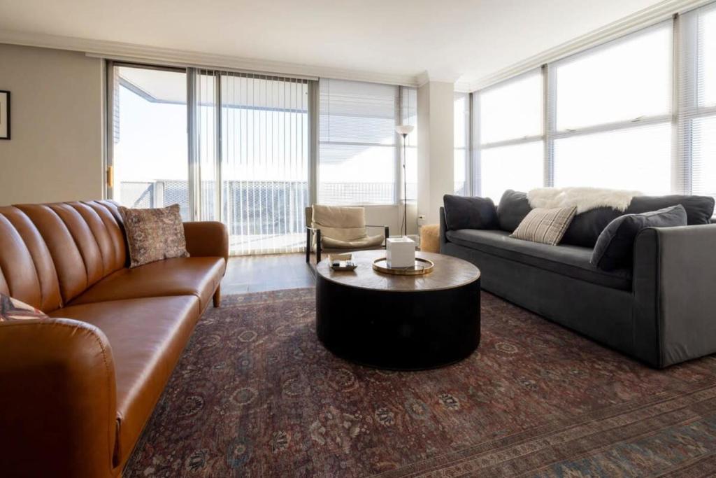 a living room with a couch and a coffee table at CozySuites 800 Tower 2BR w sky pool gym 31 in Louisville