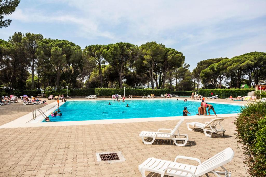 a large swimming pool with people in a park at Résidence Saint-Raphaël Valescure - maeva Home - Studio 2 personnes - Séle 41 in Valescure
