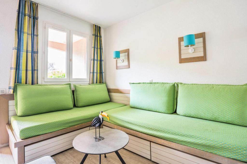 a room with green couch and a window at Résidence Saint-Raphaël Valescure - maeva Home - Studio 2 personnes - Séle 41 in Valescure