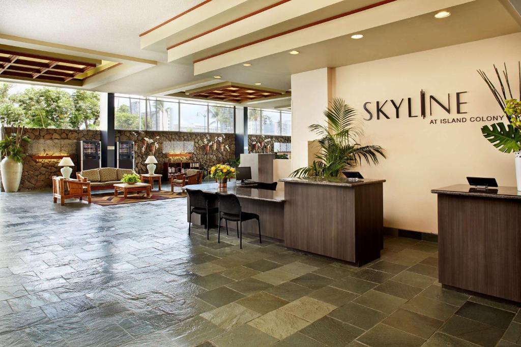 an office lobby with a large sign on the wall at Aqua Skyline at Island Colony in Honolulu
