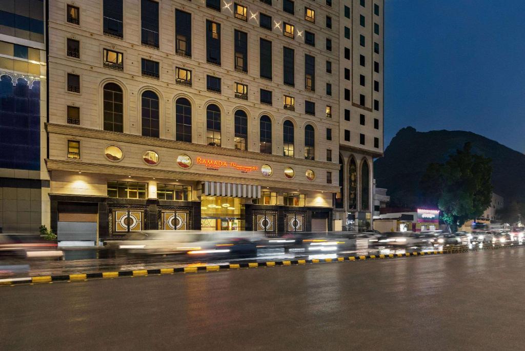 a city street with cars in front of a building at Ramada by Wyndham Makkah Zad Al Rawda in Makkah