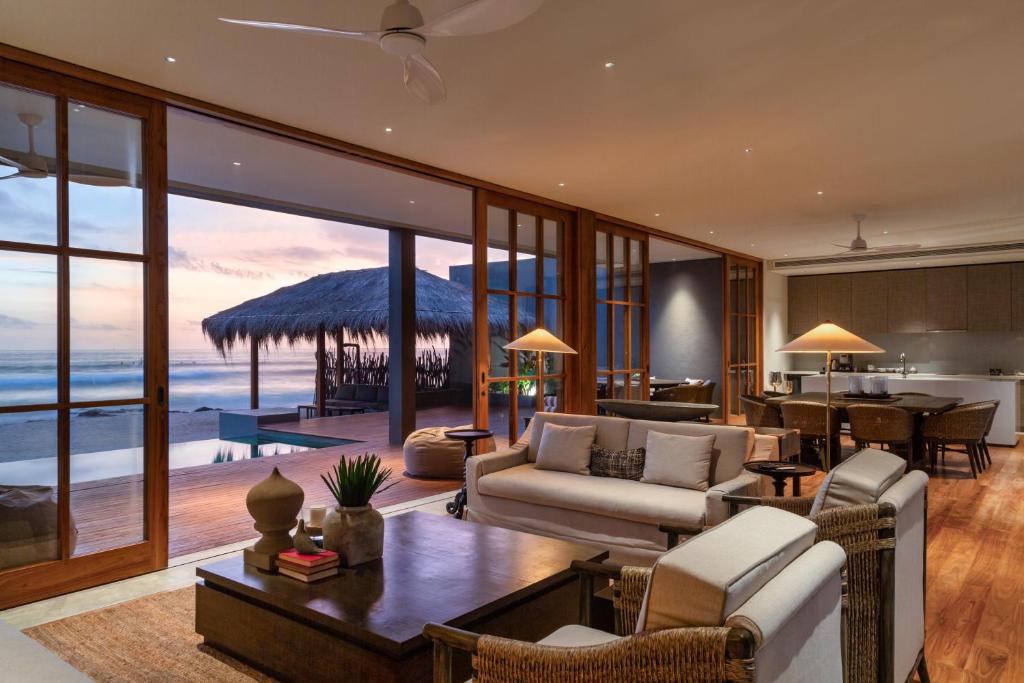 a living room with a view of the ocean at The Six in Midigama East