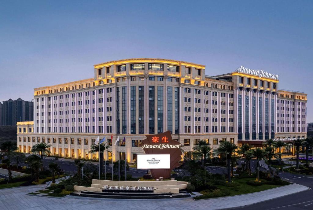 duży budynek z znakiem przed nim w obiekcie Howard Johnson by Wyndham Huaqiao Plaza Xinyu w mieście Xinyu