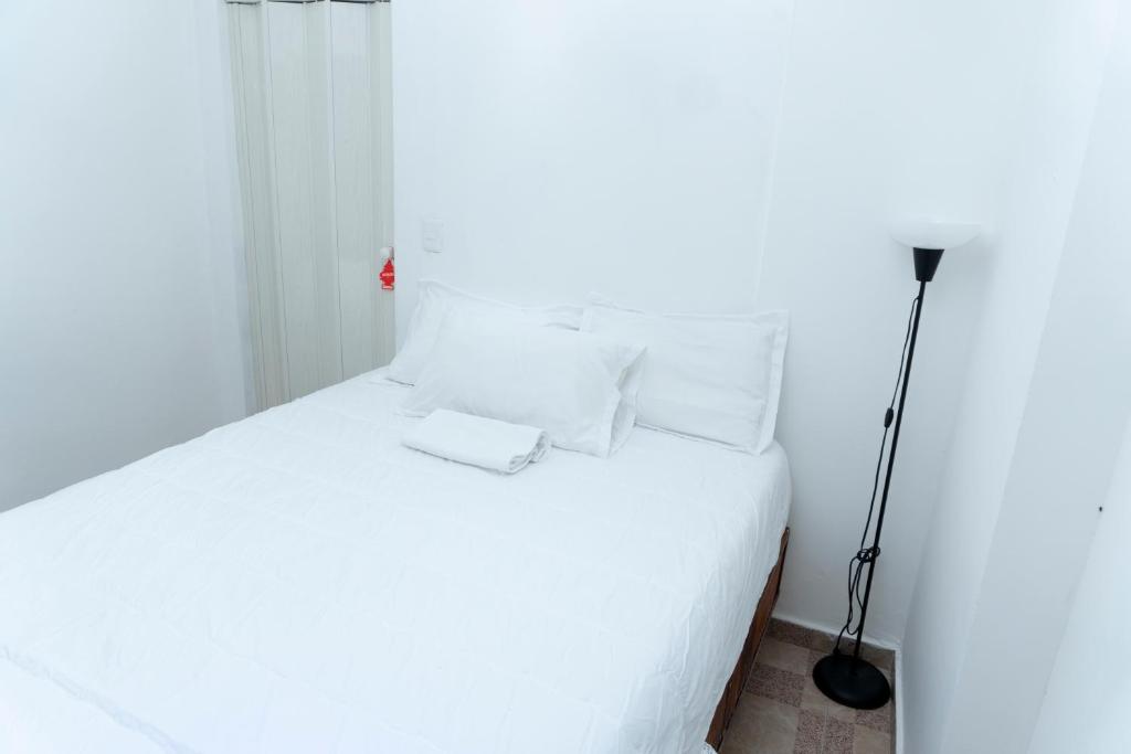Postel nebo postele na pokoji v ubytování Casa de Huespedes Colonial