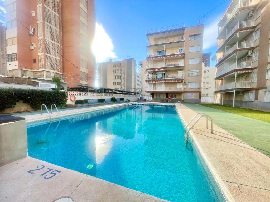a large swimming pool in the middle of a building at White House Nervion in Benidorm