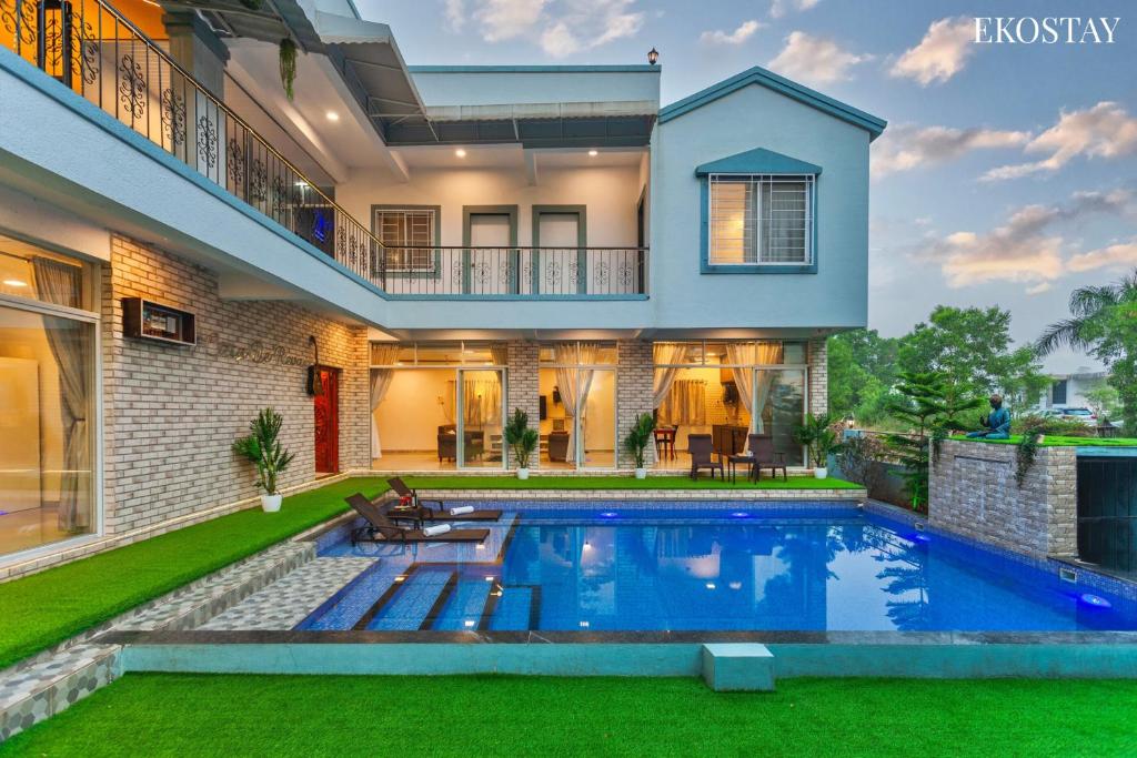 a house with a swimming pool in the yard at EKOSTAY - Casa De Reva in Lonavala