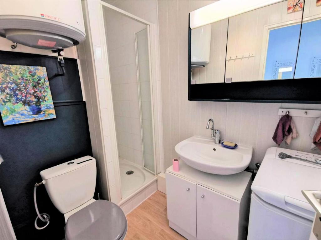 a bathroom with a white toilet and a sink at Résidence LES TERRASSES DU PORT - 2 Pièces pour 4 Personnes 04 in Port Leucate