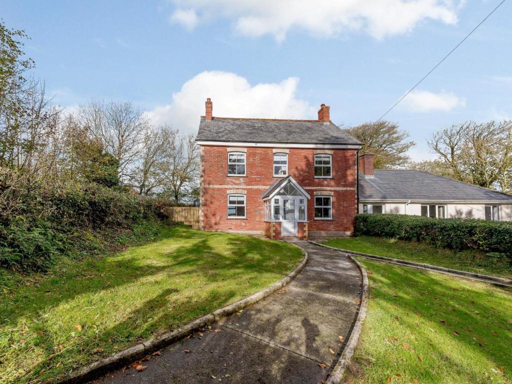 an old red brick house with a driveway at 5 Bed in Bude 79454 in Milton Damerel