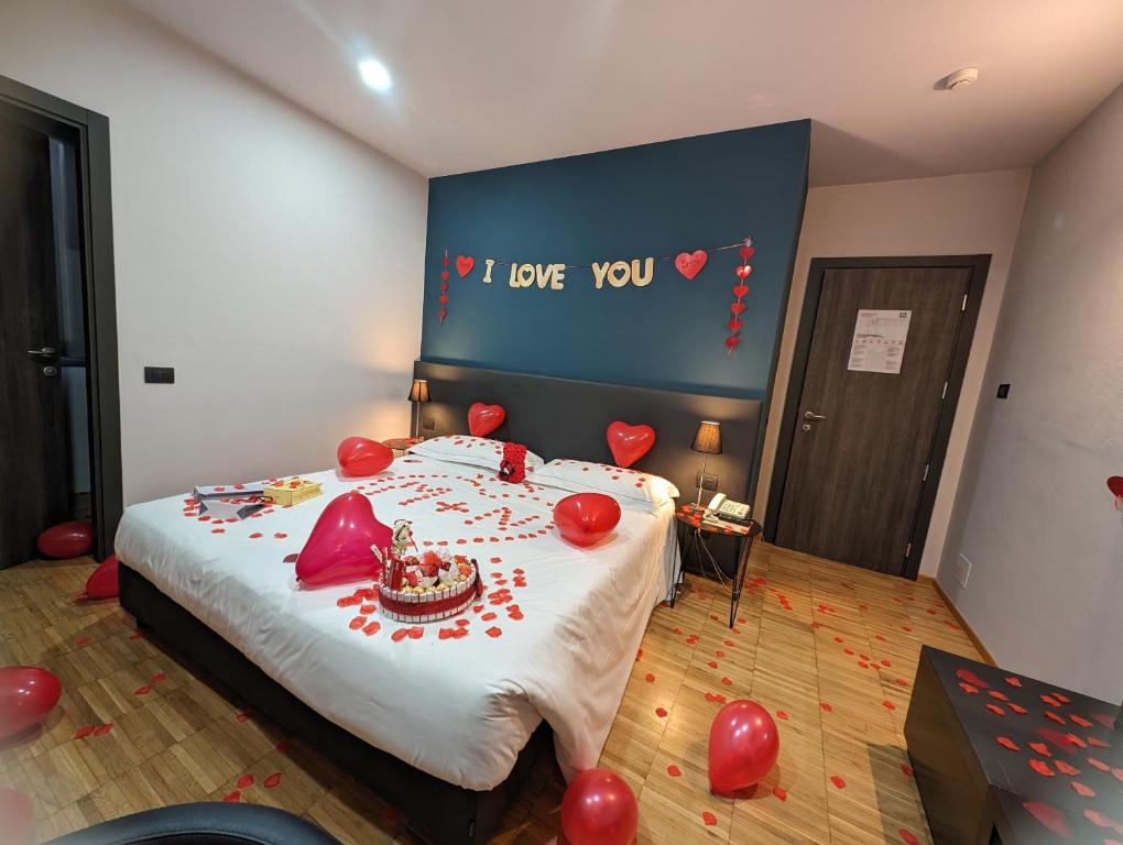 a bedroom with a bed with red balloons on it at Smart Hotel in Carpi