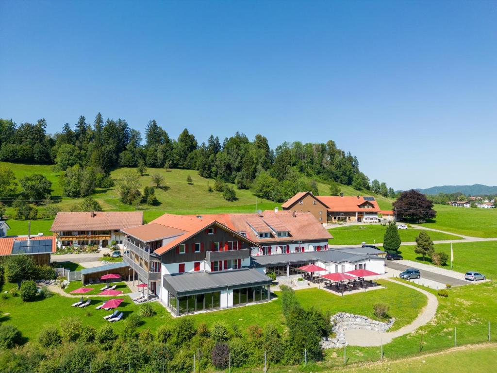 an aerial view of a large house on a hill at Sontheims Naturhotel & Spa in Maierhöfen