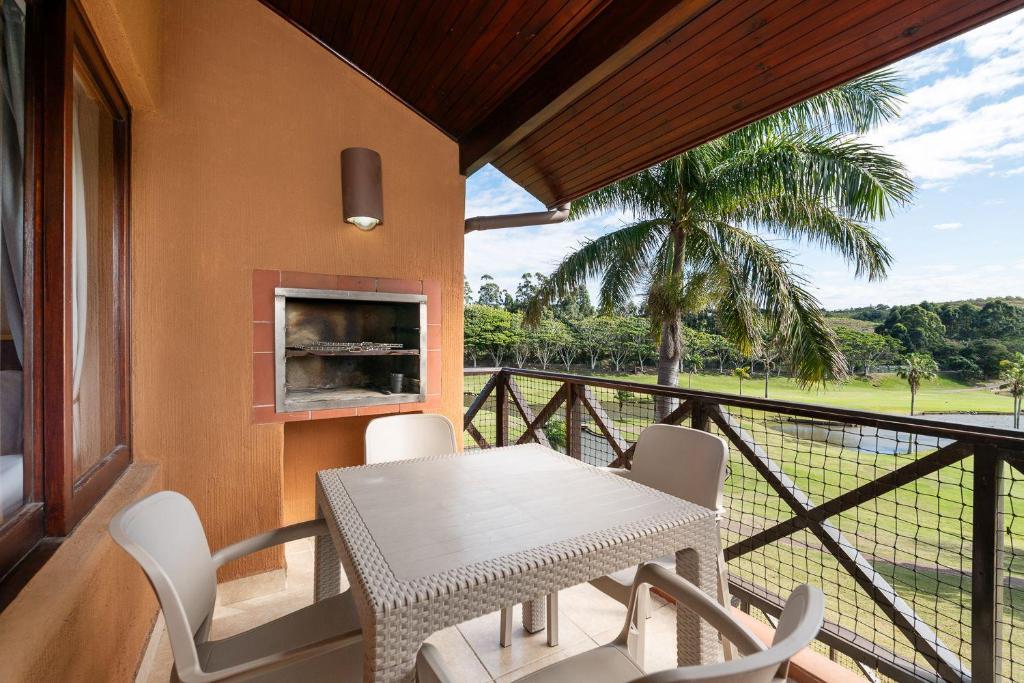 a table and chairs on a balcony with a fireplace at San Lameer Villa 10415 - 2 Bedroom Classic - 4 pax - San Lameer Rental Agency in Southbroom