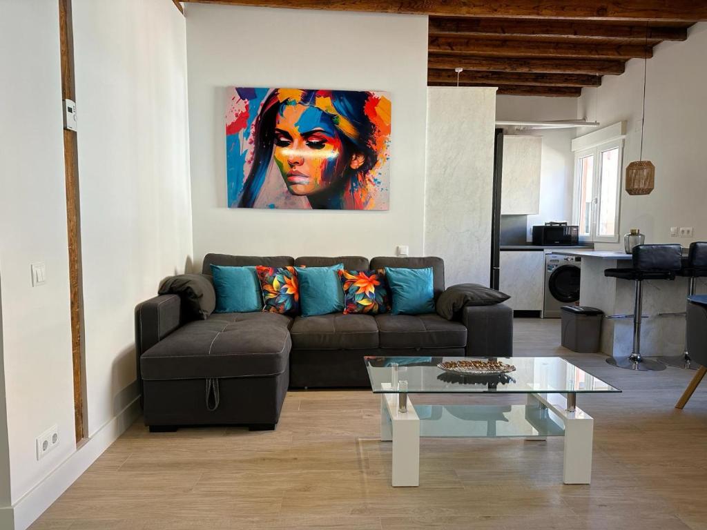 a living room with a couch and a painting on the wall at Salamanca Apartment in Madrid