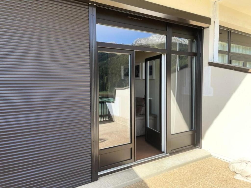 a sliding glass door on the side of a house at Résidence Les Glovettes - Studio pour 4 Personnes 164 in Villard-de-Lans