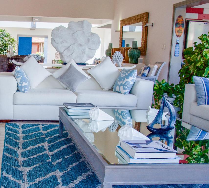 a living room with a white couch and a glass table at Villa Bikini in Punta Cana