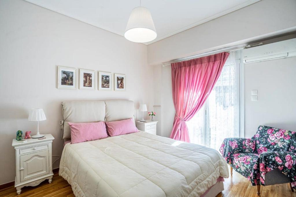 a bedroom with a large bed and a window at Lovely 1 Bd apt in Kalithea with Balcony in Athens