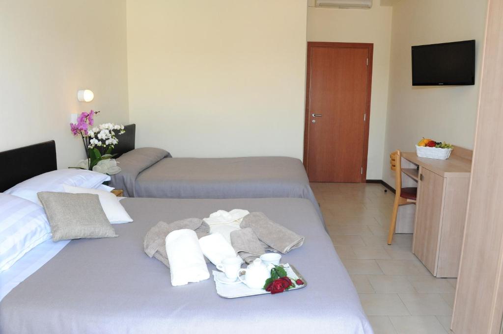 Postel nebo postele na pokoji v ubytování Hotel Lanzoni