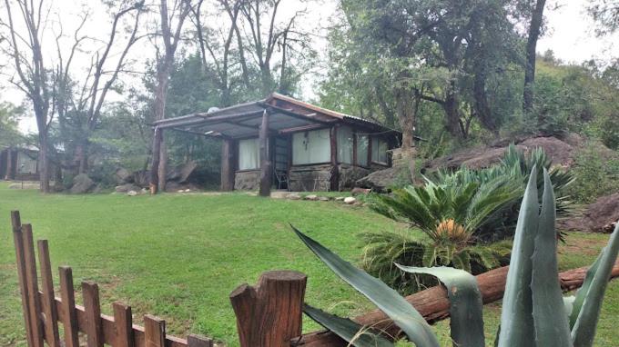 a small house in a field with a fence at Complejo Cerro Norte in Piedras Blancas