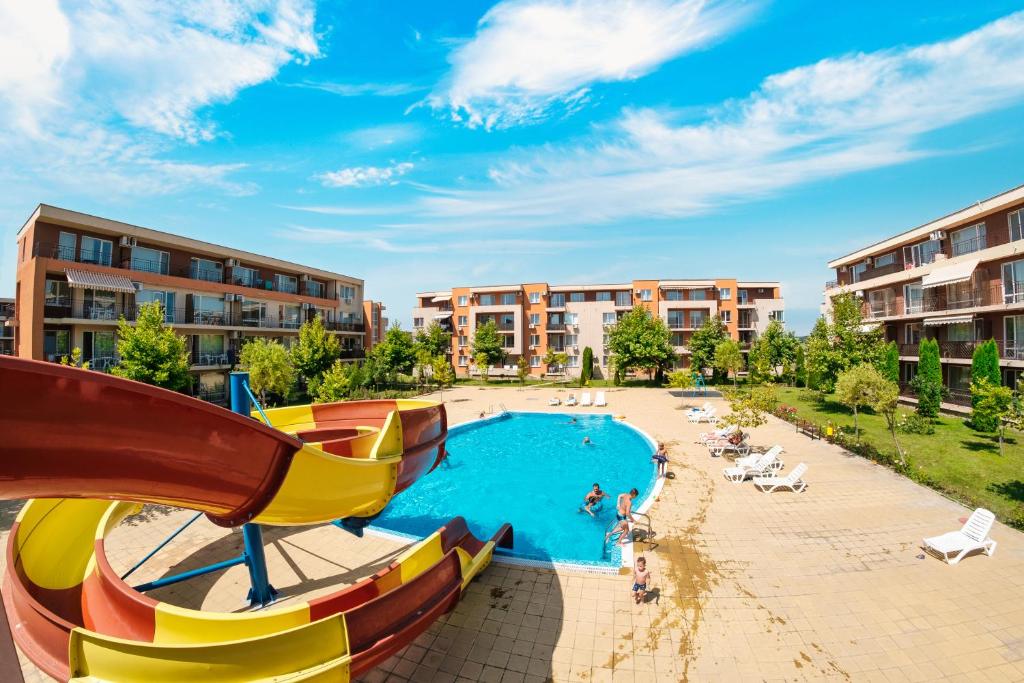 a pool at a resort with a slide at Nessebar and Holiday Fort Apartments in Sunny Beach