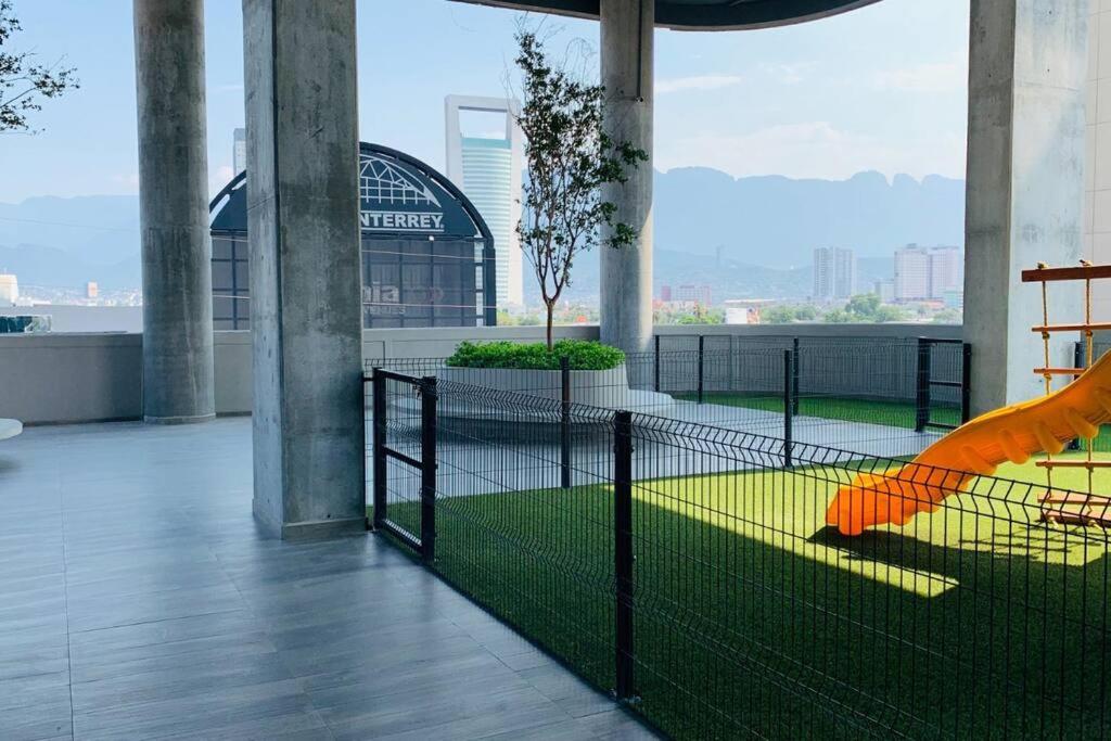 a balcony with a fence and a playground at Departamento Arena Vive in Monterrey