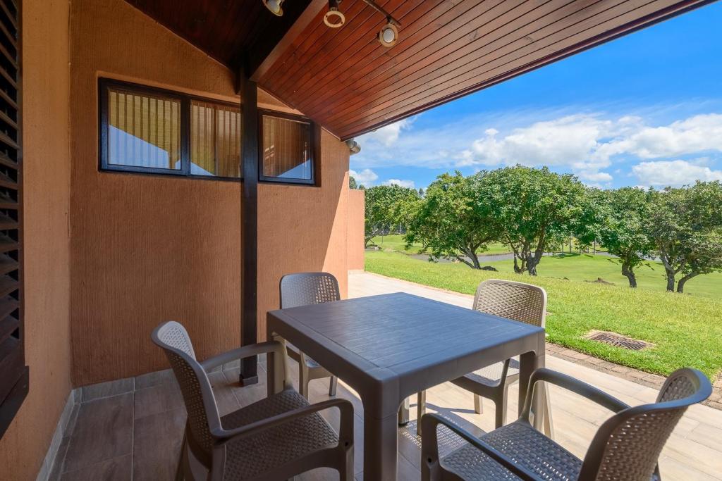 a table and chairs on a porch with a view at San Lameer Villa 10417 - 1 Bedroom Classic - 2 pax - San Lameer Rental Agency in Southbroom