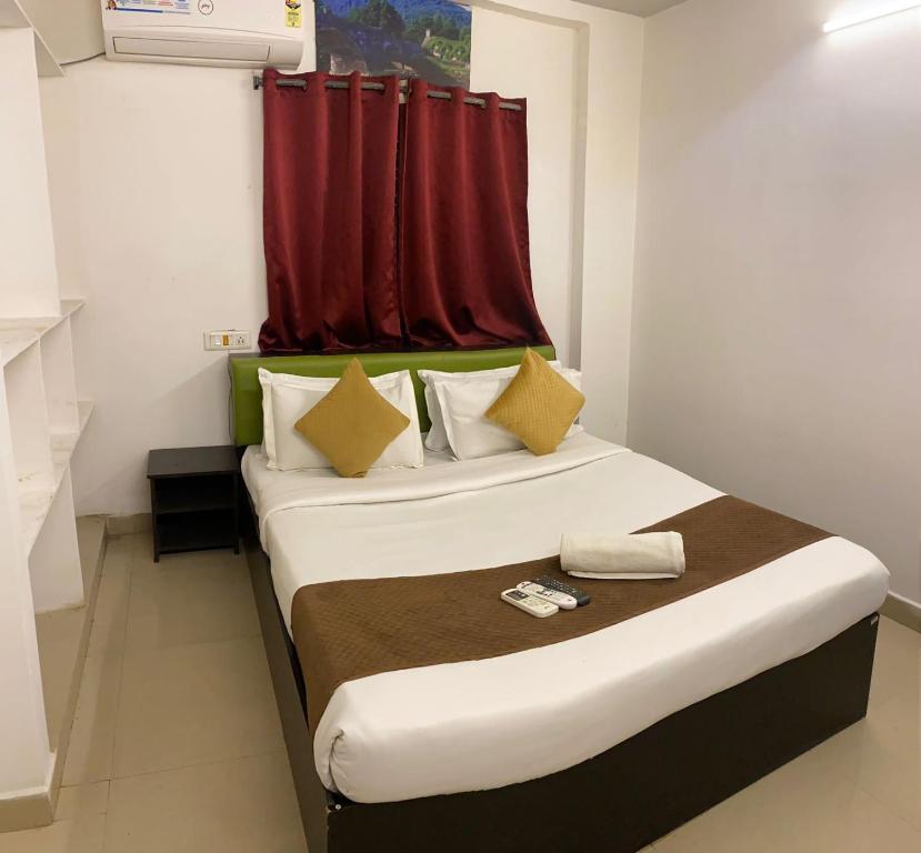 a bedroom with a bed with a red curtain at Hotel Fortune Heights in Hyderabad