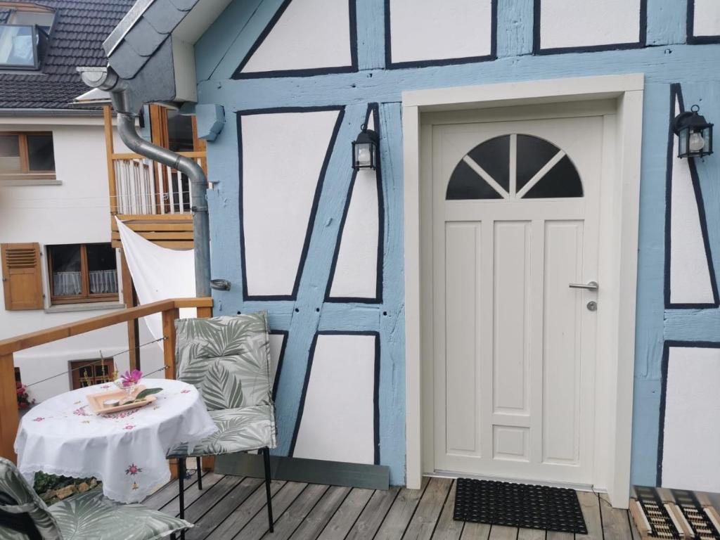 a front door of a house with a table at Ferienwohnung in Anni's Ferienhaus 