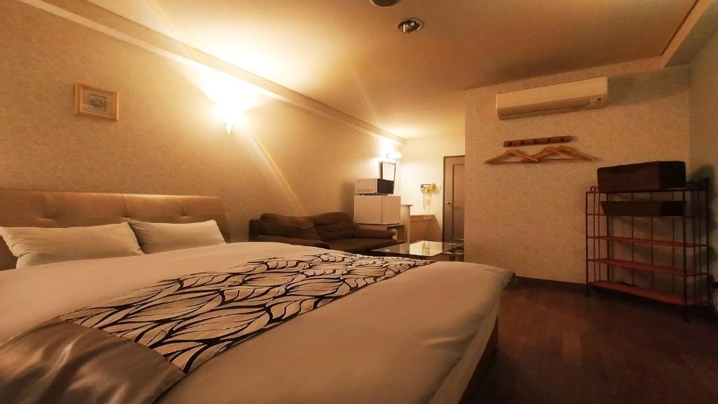 Postel nebo postele na pokoji v ubytování Hotel Wave大人専用