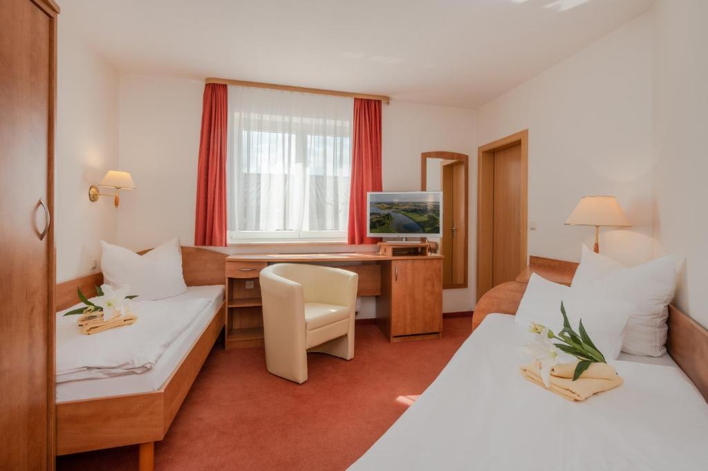 Postel nebo postele na pokoji v ubytování Gasthaus & Pension Natzke