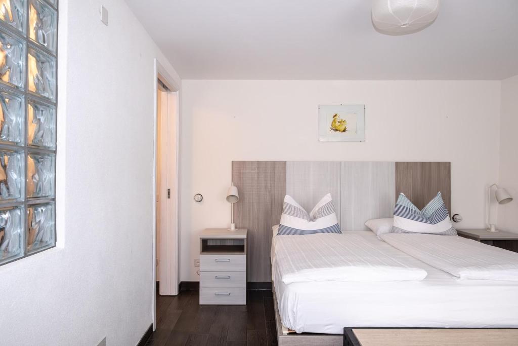 Postel nebo postele na pokoji v ubytování Guesthouse Arosio B&B