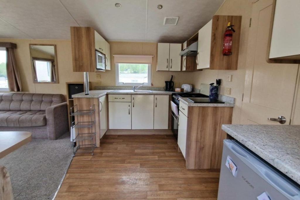 a small kitchen in a tiny house with a couch at HO48 - Coghurst Hall - Hastings, East Sussex in Westfield