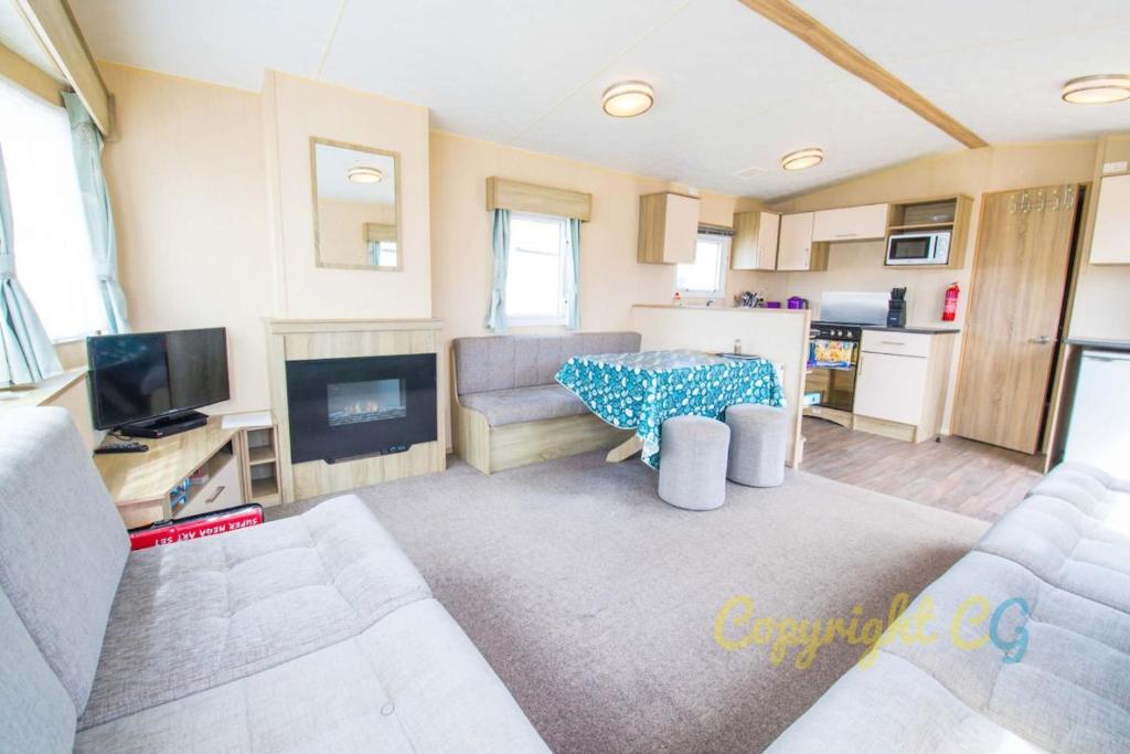 a living room with a couch and a table at SP84 - Camber Sands Holiday Park - 3 Bedroom - Sleeps 8 - Private Parking in Camber