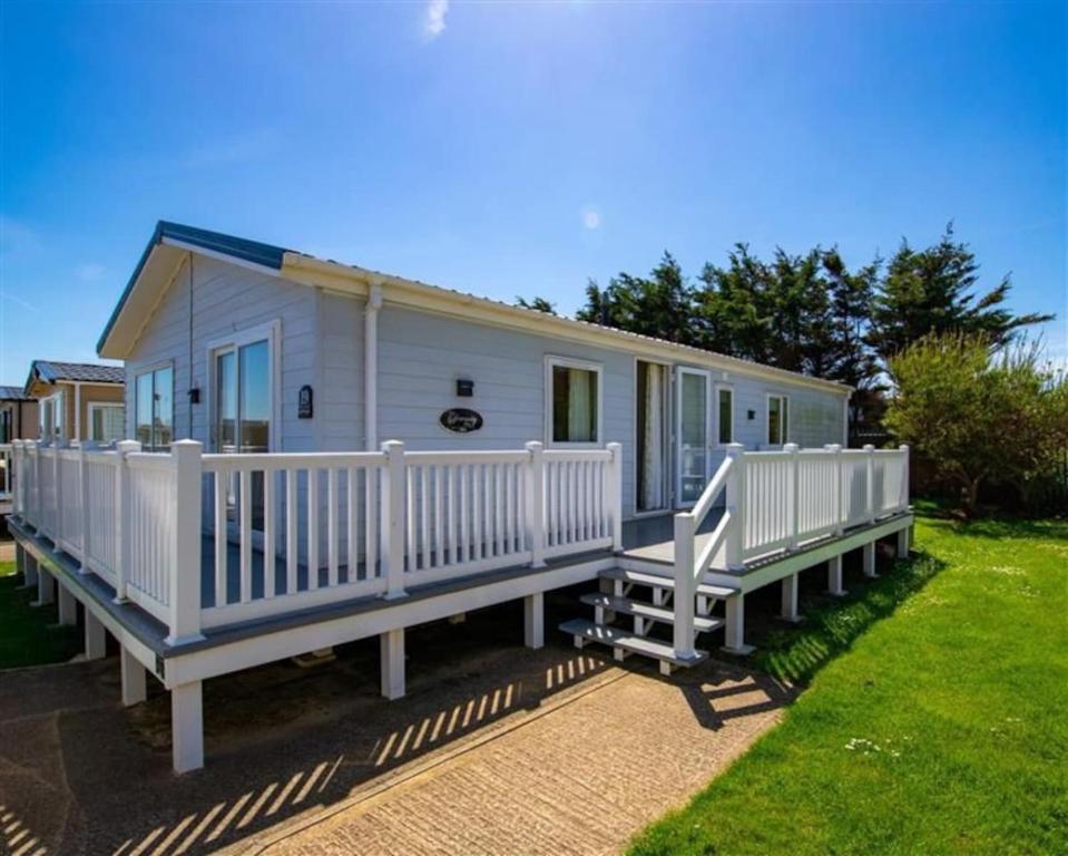 Casa móvil con barandillas blancas y porche en SBL19 - Parkdean Resorts, Camber Sands, en Camber