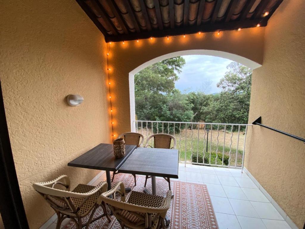 stół i krzesła na patio z oknem w obiekcie Résidence Les Parcs de Grimaud - maeva Home - Appartement 2 Pièces 4 Personnes - Sélection MAE-0194 w mieście Grimaud