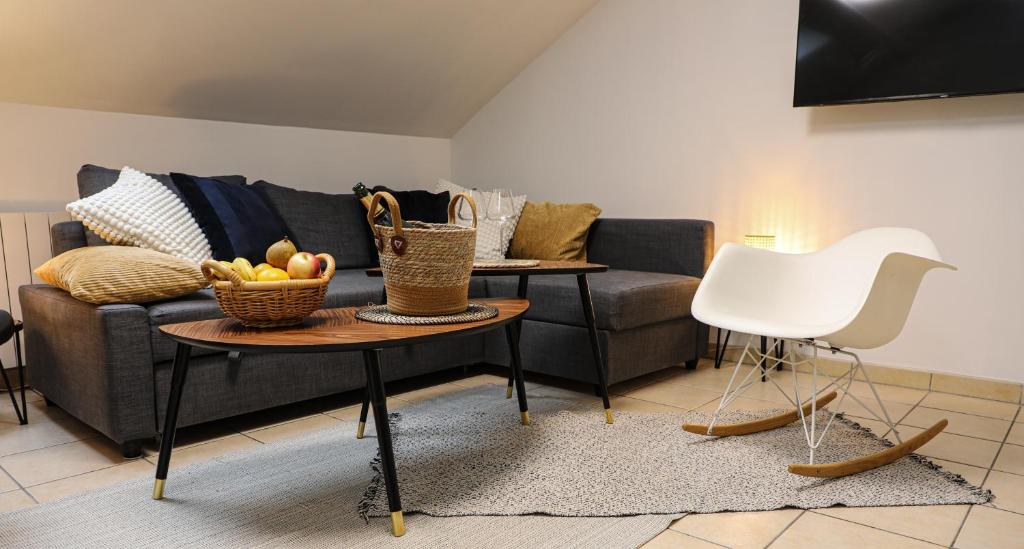 a living room with a couch and a table at Gite Urbain - La bulle de champagne - Parking in Épernay