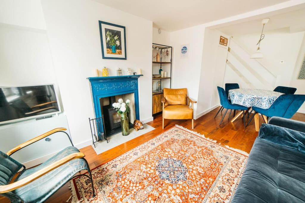 a living room with a couch and a fireplace at Charming & Stylish 2-Bed House - 20 min Walk to Centre in Bath