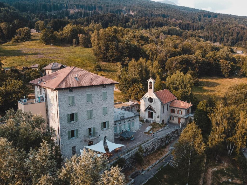 an aerial view of a building with a church at Casa del Parco Adamello in Cevo