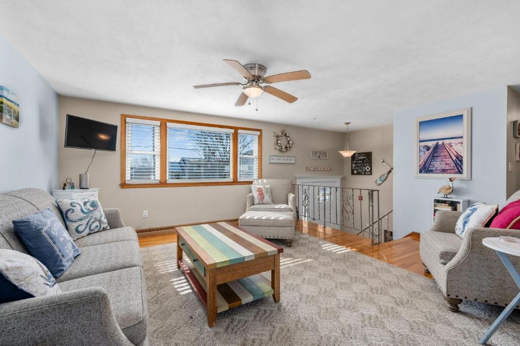 a living room with a couch and a ceiling fan at Family Cape Escape—Beach, Boardwalk Game Room in Sandwich