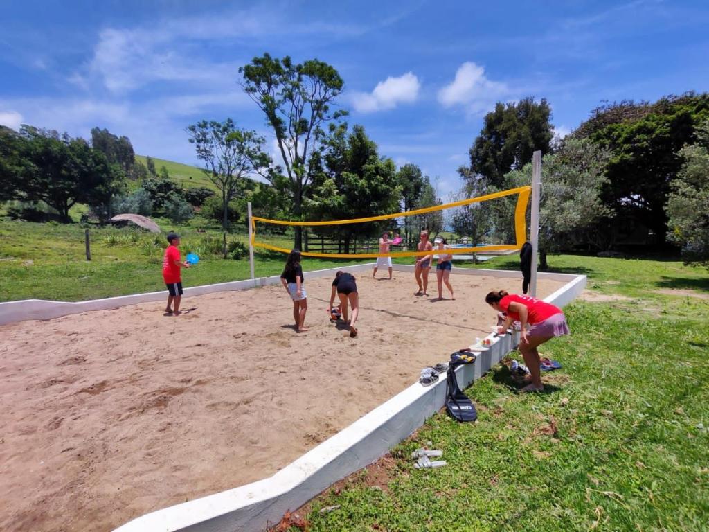 a group of people playing a game of volley ball at Sítio paiol Velho in Cristina