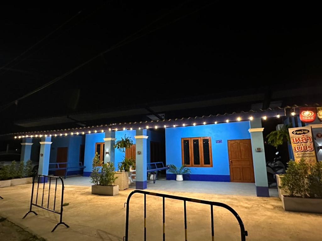 a blue building with lights on it at night at Blue Sky Home stay 