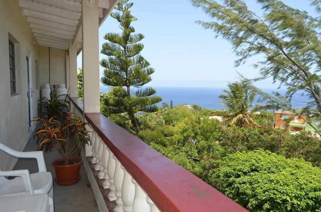 a balcony with a view of the ocean at Seaview Apartments in Cudjoe Head