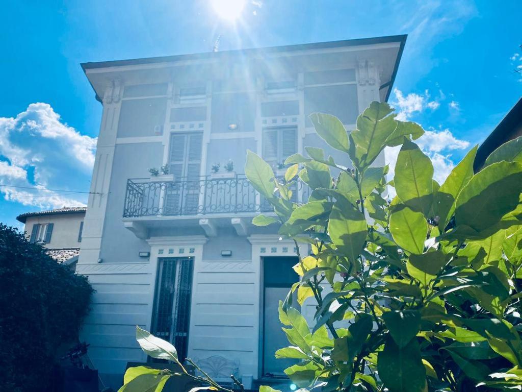 a white house with a balcony on top of it at Villa Martina Retreat in Lecco