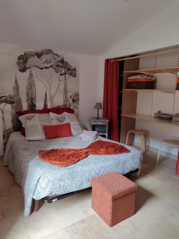 a bedroom with a bed with a red blanket on it at Chez Monique et Rémi in Avignon
