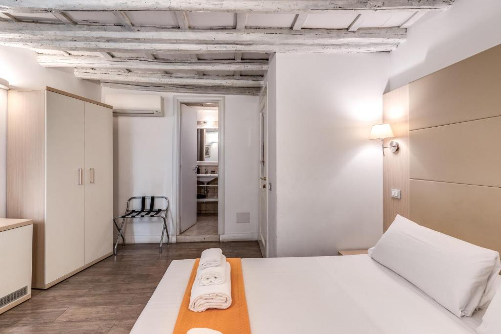 a bedroom with a white bed in a room at Magenta Deluxe Cancello in Rome