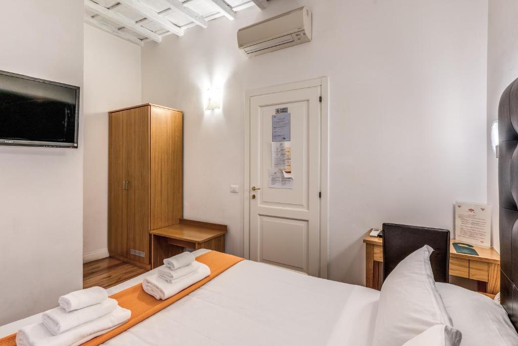 a bedroom with a bed with two towels at Magenta Deluxe Cancello in Rome