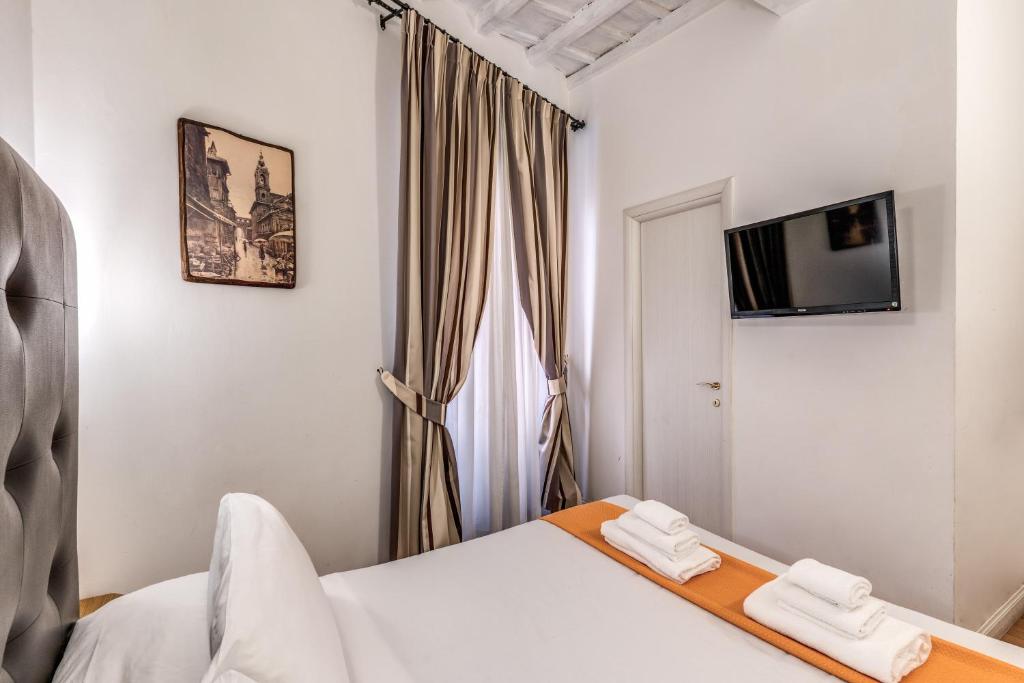 a bedroom with a bed with two white towels at Magenta Deluxe Cancello in Rome