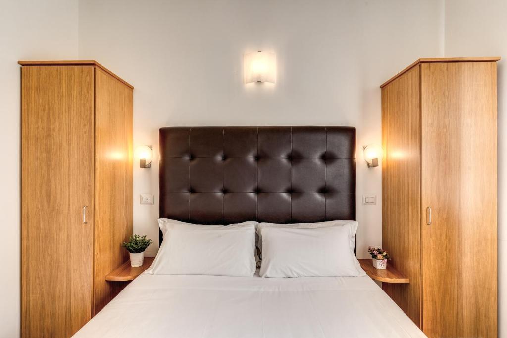 a bedroom with a large bed with a black headboard at Magenta Deluxe Cancello in Rome