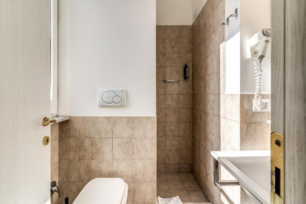 a bathroom with a toilet and a sink at Magenta Deluxe Cancello in Rome