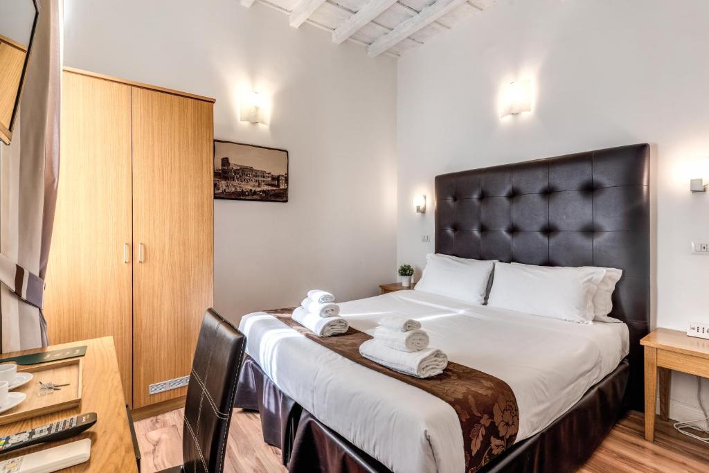 a bedroom with a large bed with a black headboard at Magenta Deluxe Cancello in Rome